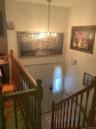 Tiled foyer with a chandelier