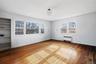Unfurnished room featuring radiator and hardwood / wood-style flooring