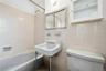 Full bath with  shower combination and tile walls
