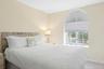 Bedroom featuring baseboards and carpet floors