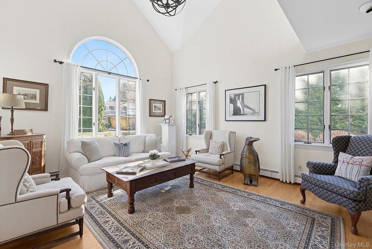 Living room featuring high vaulted ceiling and light wood-type flooring