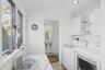 Laundry area with ornamental molding, independent washer and dryer, light wood-style floors, a baseboard heating unit, and recessed lighting