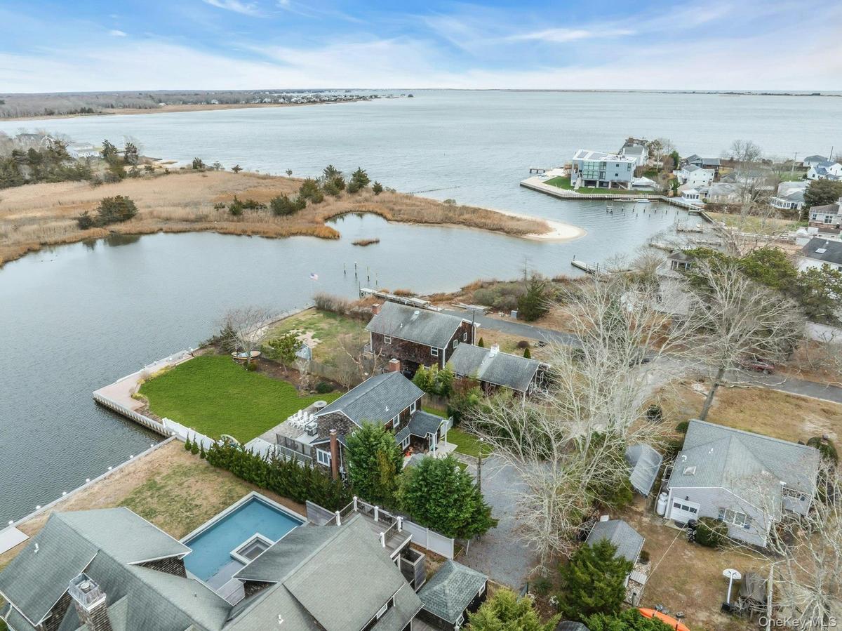 Aerial perspective of suburban area featuring a large body of water