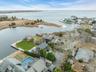 Aerial perspective of suburban area featuring a large body of water