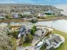 Aerial view of residential area featuring a nearby body of water