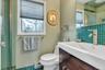 Bathroom featuring vanity, a stall shower, and a baseboard radiator