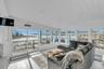 Sunroom / solarium featuring lofted ceiling, a water view, recessed lighting, wood-type flooring, and wood ceiling