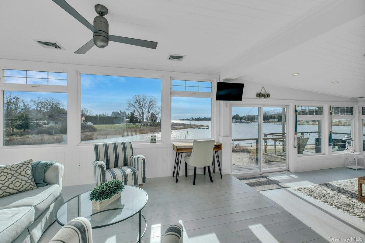 Sunroom / solarium with healthy amount of natural light and wood finished floors