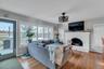 Living area featuring a brick fireplace and hardwood / wood-style flooring