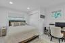 Bedroom with an office area, multiple windows, ornamental molding, a closet, and recessed lighting