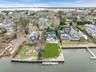 Aerial perspective of suburban area featuring a large body of water