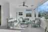Sunroom / solarium featuring wood walls, wood-type flooring, and ornamental molding