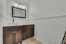 Bathroom featuring vanity, a wainscoted wall, and ornamental molding