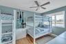 Bedroom featuring a water view, light wood-style floors, and ceiling fan