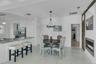 Dining space with a glass covered fireplace and a chandelier