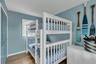 Bedroom with wood finished floors and a closet