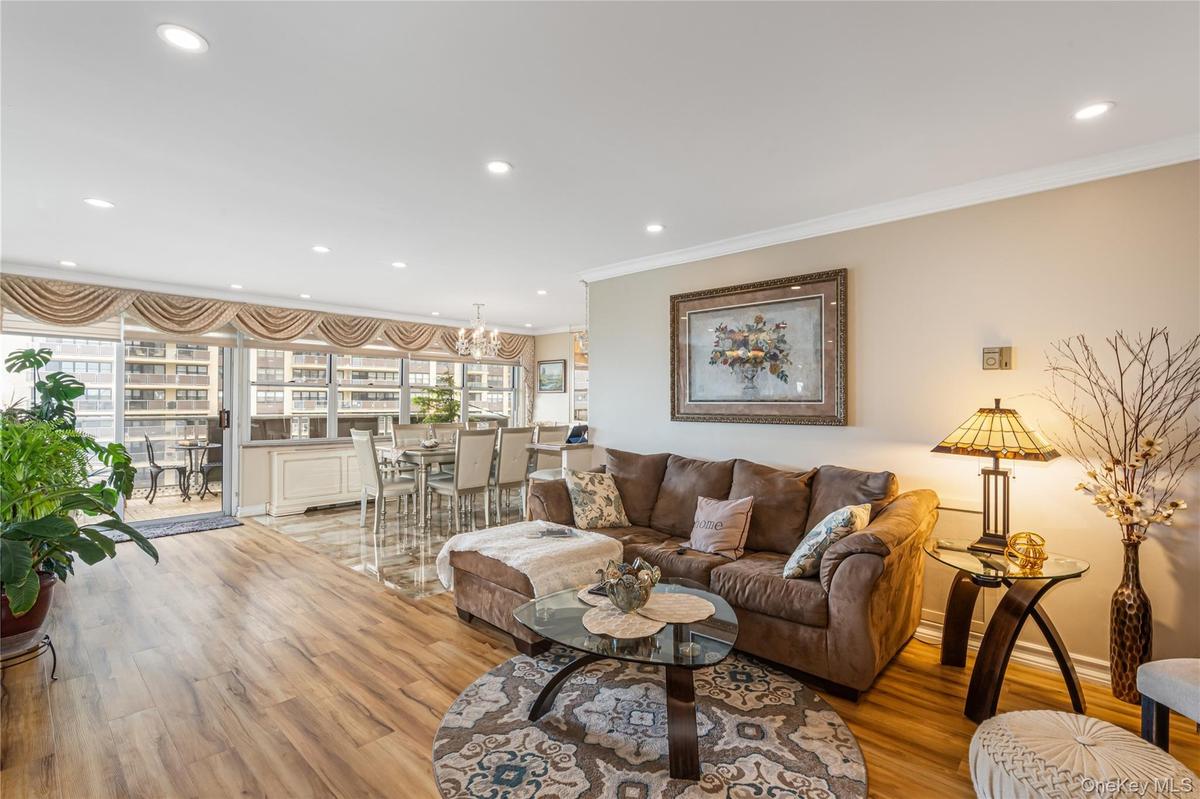 Living room featuring crown molding, light wood-style floors, and recessed lighting