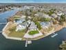 Aerial view of property's location featuring a nearby body of water and nearby suburban area