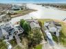 Aerial view of residential area featuring a large body of water