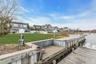 Dock area with a residential view and a lawn