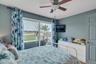 Bedroom with a ceiling fan and access to outside