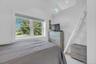 Bedroom featuring lofted ceiling and light wood-style flooring