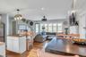 Kitchen featuring white cabinets, freestanding refrigerator, a kitchen island, hanging light fixtures, and recessed lighting