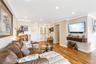 Living room featuring light wood finished floors, recessed lighting, ornamental molding, baseboards, and french doors