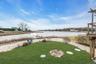 View of green lawn with a water view