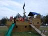 Communal playground featuring a wooden deck and a yard