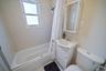 Full bathroom with vanity, shower / bathtub combination with curtain, and tile patterned floors