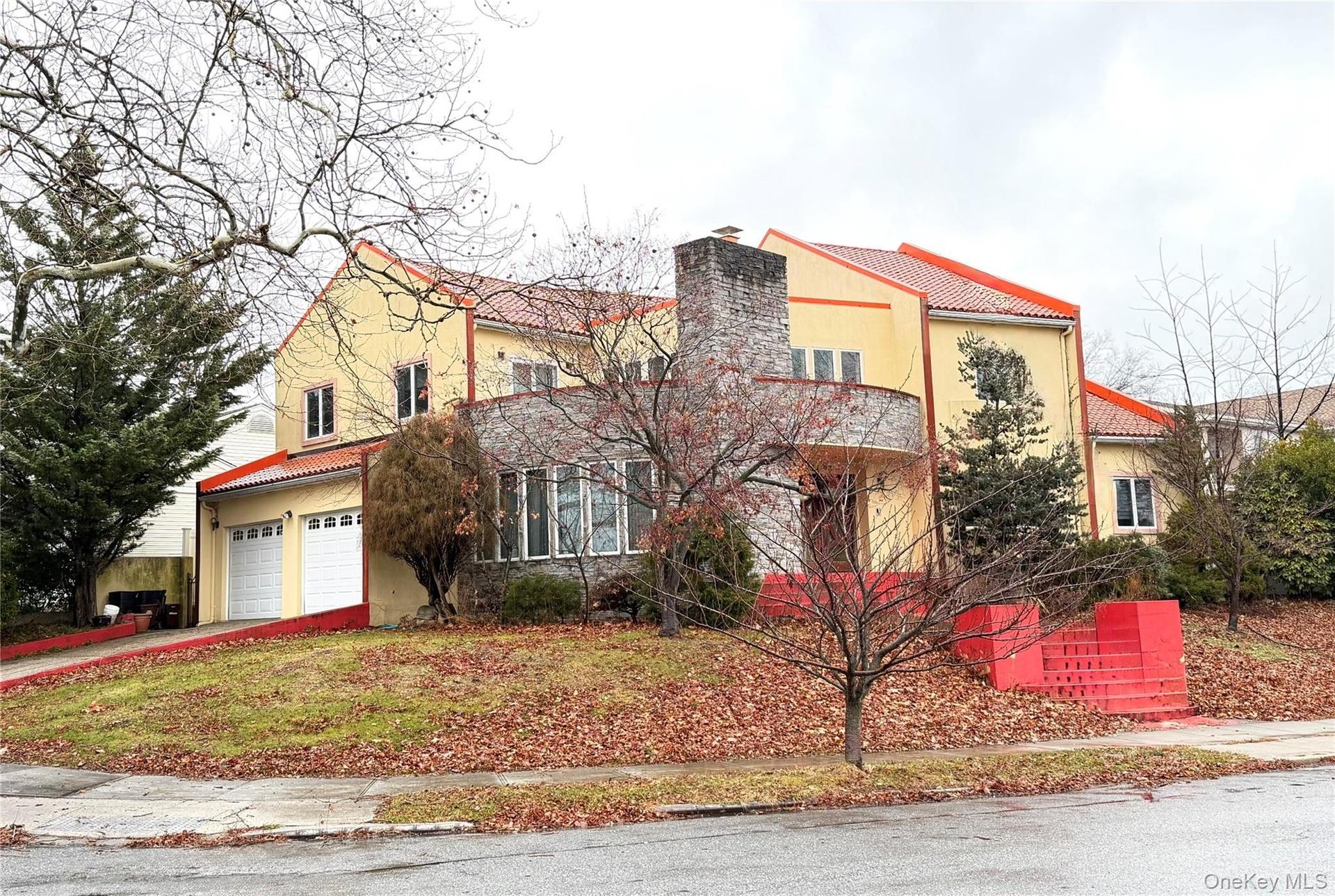 Mediterranean / spanish home with a tiled roof, a chimney, driveway, and an attached garage
