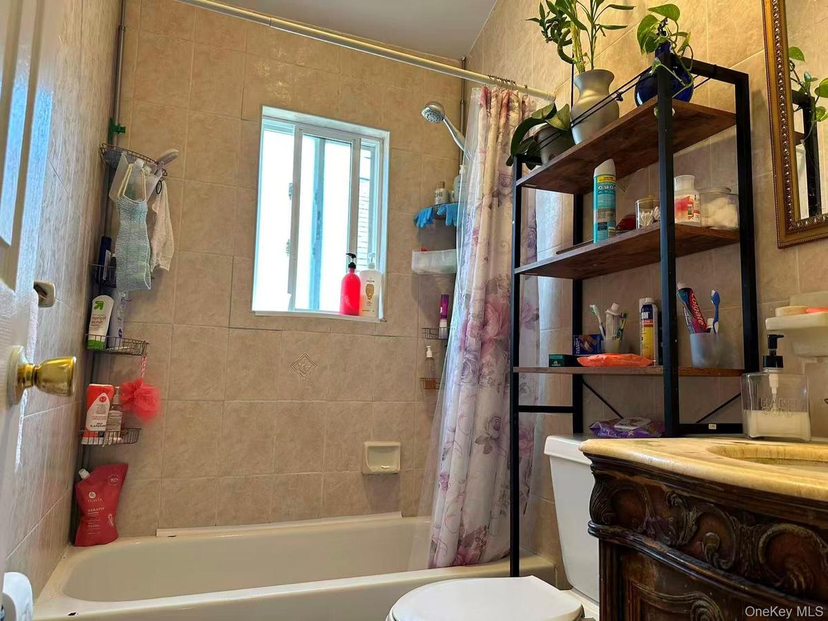 Full bathroom featuring shower / tub combo with curtain and vanity