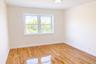 Unfurnished room featuring light wood finished floors and baseboards