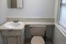 Half bathroom with vanity and tile patterned flooring