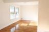 Spare room featuring light wood finished floors and baseboards