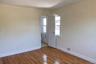 Unfurnished room with baseboards and hardwood / wood-style floors