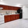 Kitchen featuring white gas stove, freestanding refrigerator, exhaust hood, light tile patterned floors, and recessed lighting