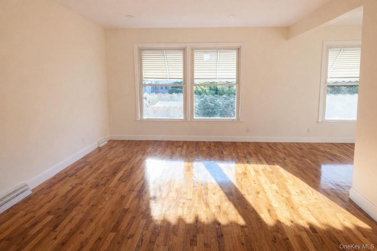 Empty room featuring wood finished floors and baseboards