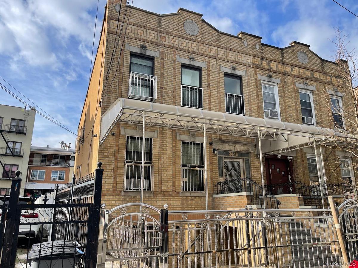 View of building exterior featuring a fenced front yard