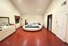 Bedroom featuring high vaulted ceiling and dark wood finished floors