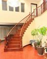Stairway featuring wood finished floors and a high ceiling