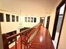 Corridor featuring an upstairs landing, wood finished floors, and crown molding