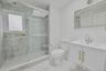 Full bath featuring vanity, a shower stall, and light marble finish floors