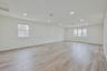 Empty room with light wood-style floors, healthy amount of natural light, and recessed lighting