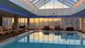 Indoor community pool with a patio area