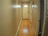 Doorway with baseboards, baseboard heating, and light wood finished floors