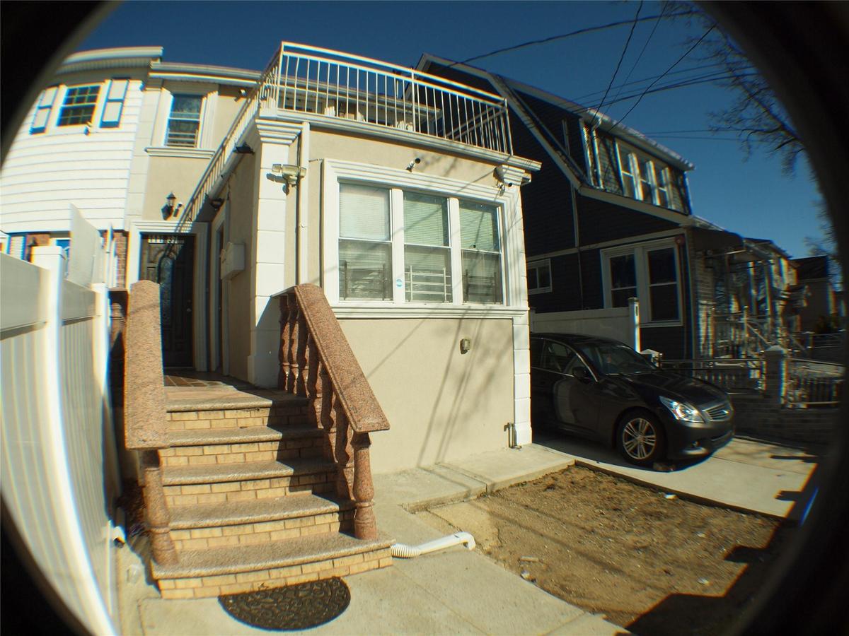 Rear view of house with stucco siding and a balcony