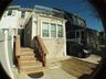 Rear view of house with stucco siding and a balcony