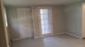 Doorway to outside featuring ornamental molding and a baseboard heating unit